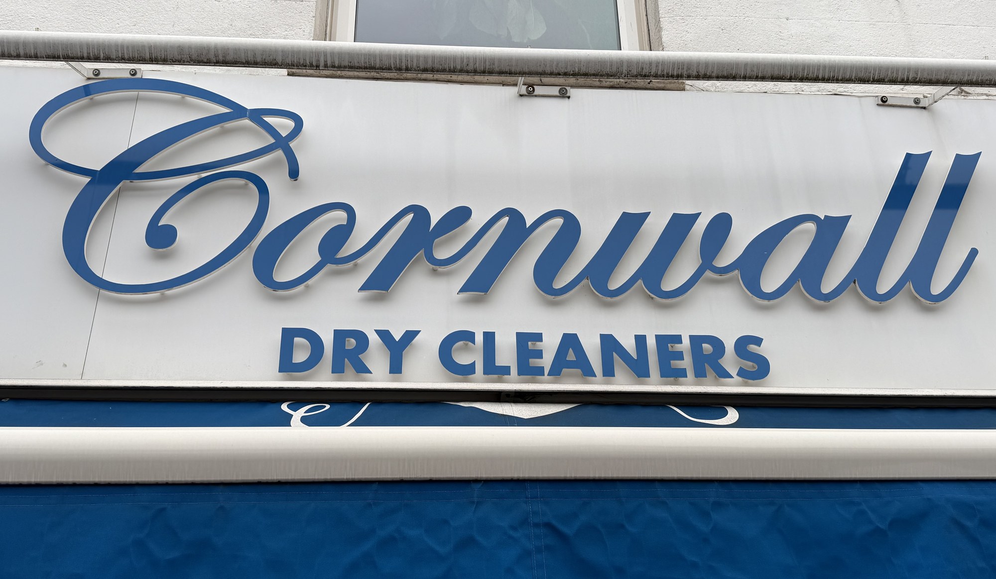 Cornwall script lettering and navy awning on the Haven Lane fascia
